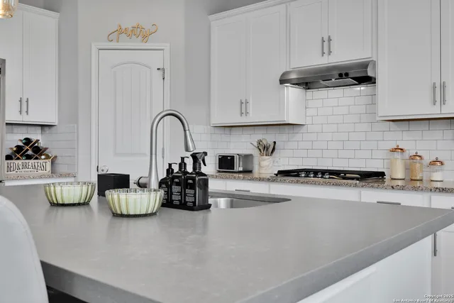 a view of a dining room with a table and chairs