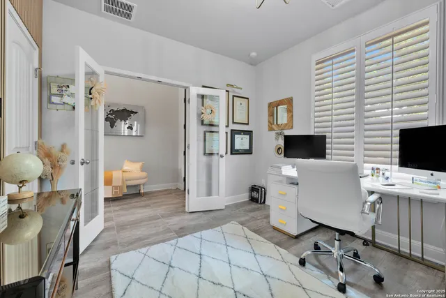 a view of a dining room with furniture and a chandelier
