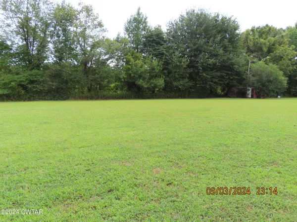 a view of a large pool with a yard