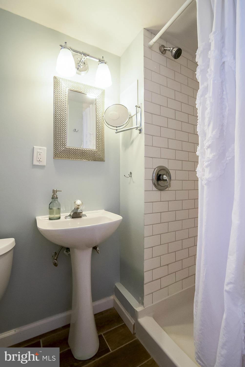 245 Blenheim Road Baltimore, MD 21212 - Photo 13 of 27 a bathroom with a sink a toilet and shower