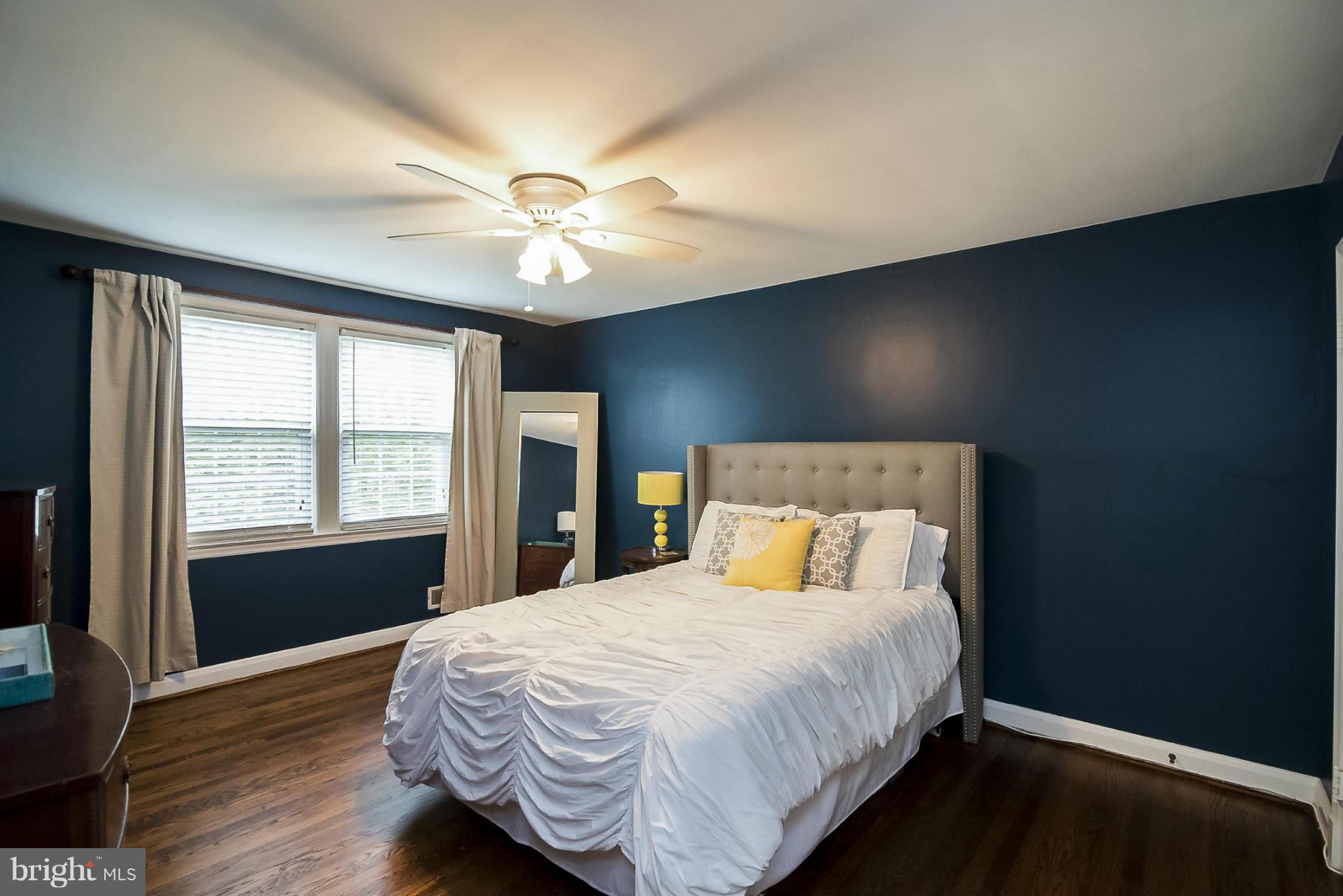245 Blenheim Road Baltimore, MD 21212 - Photo 14 of 27 a bedroom with a large bed and wooden floor