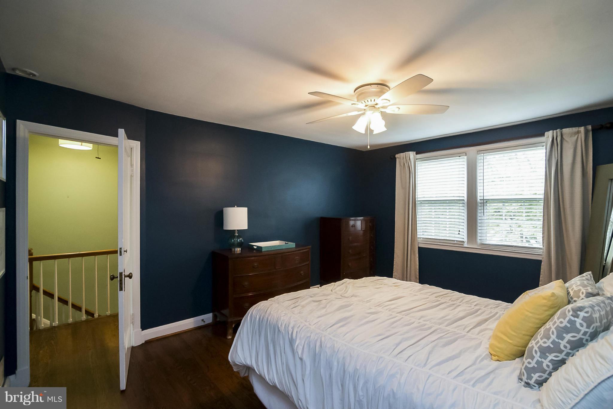 245 Blenheim Road Baltimore, MD 21212 - Photo 15 of 27 a bedroom with a bed and a chandelier