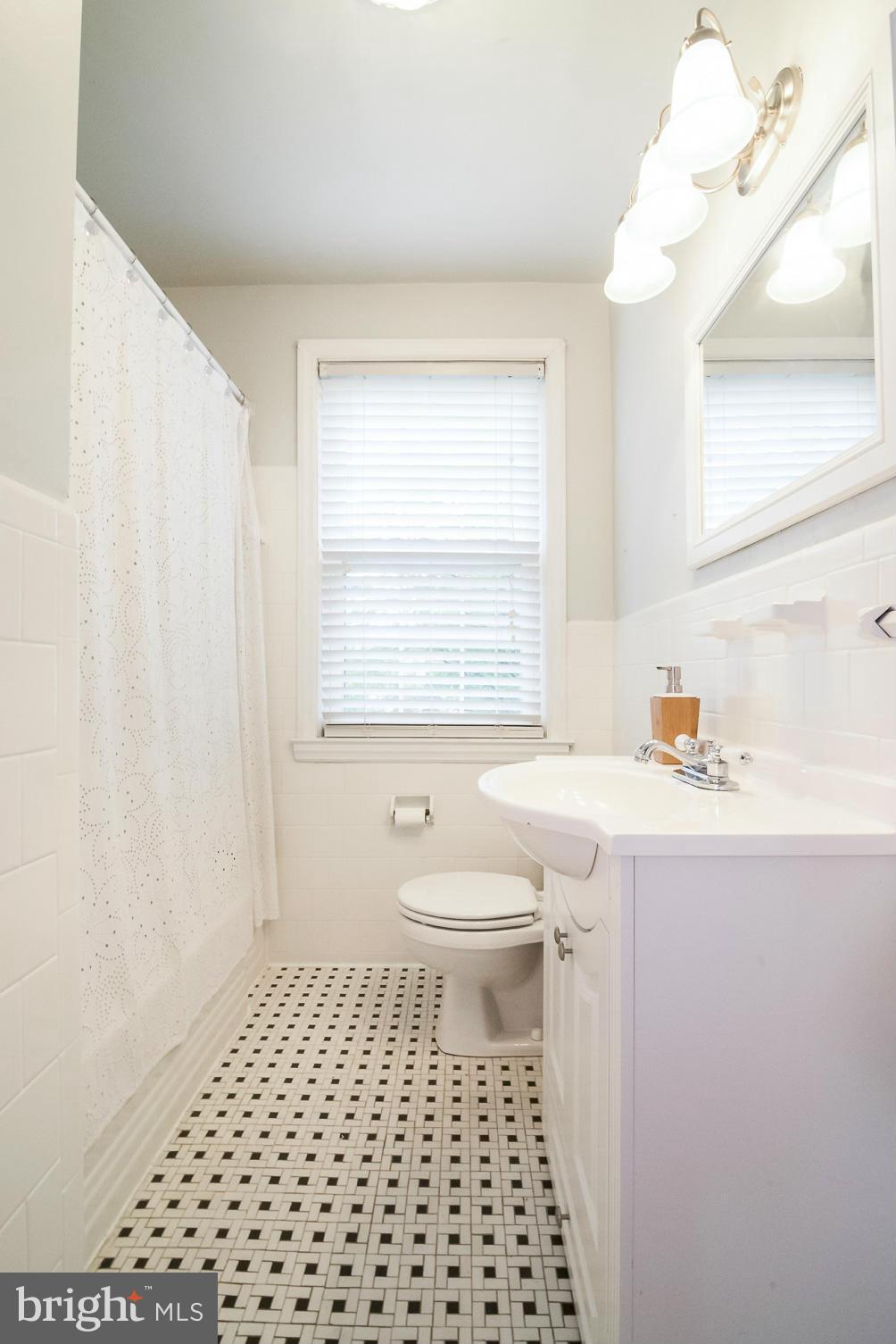 245 Blenheim Road Baltimore, MD 21212 - Photo 16 of 27 a bathroom with a sink a toilet and a window