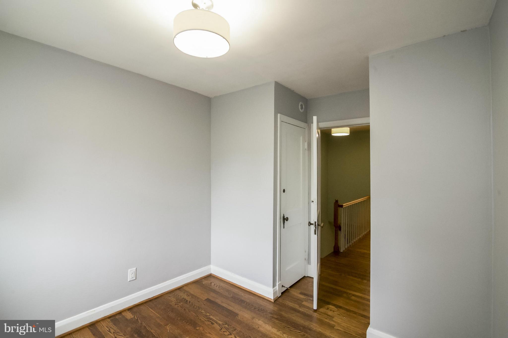 245 Blenheim Road Baltimore, MD 21212 - Photo 19 of 27 a view of a room with wooden floor and white walls