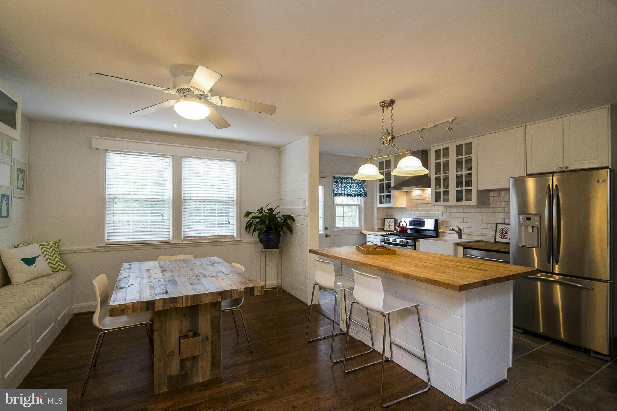 245 Blenheim Road Baltimore, MD 21212 - Photo 5 of 27 a kitchen with sink a refrigerator and chairs