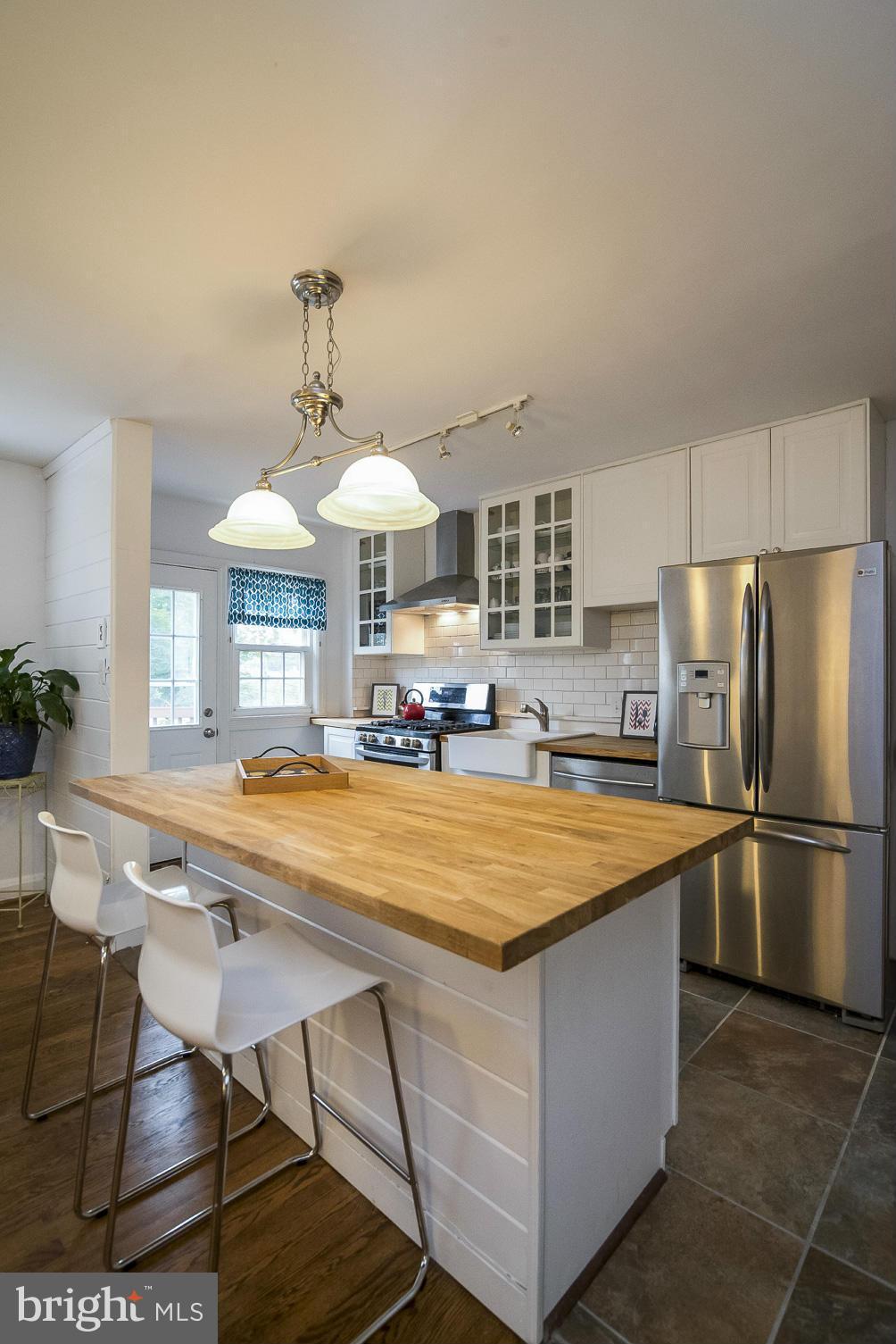 245 Blenheim Road Baltimore, MD 21212 - Photo 8 of 27 a kitchen with stainless steel appliances granite countertop a sink and a refrigerator