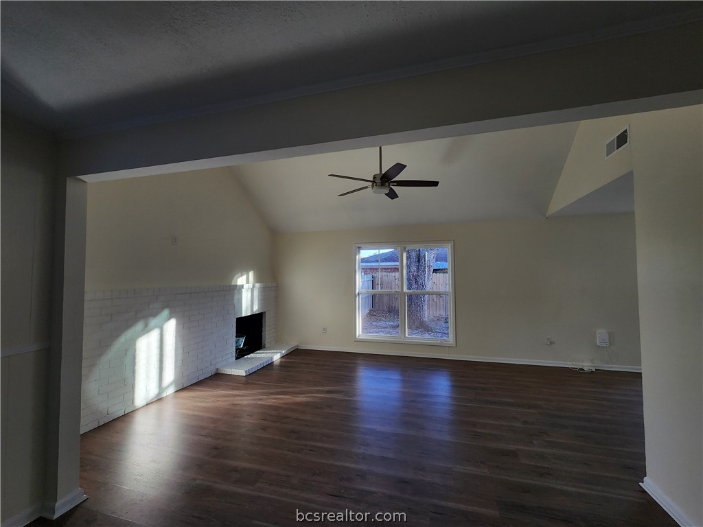 1405 Broadmoor Drive Bryan, TX 77802 - Photo 3 of 27 a view of a livingroom with wooden floor a ceiling fan and windows