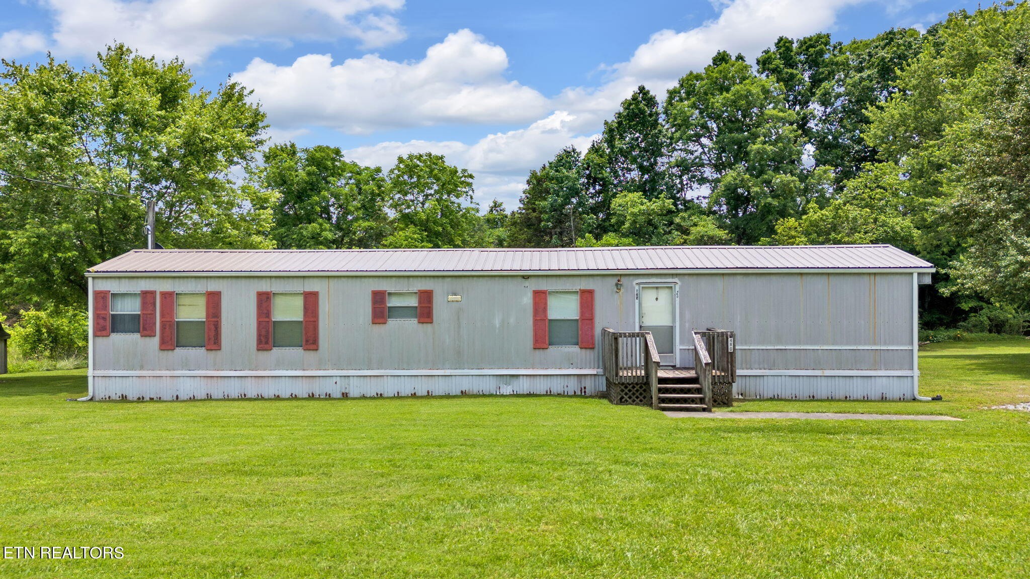 480 Oasis Road Bulls Gap, TN 37711 - Photo 2 of 16 a front view of house with yard and seating area