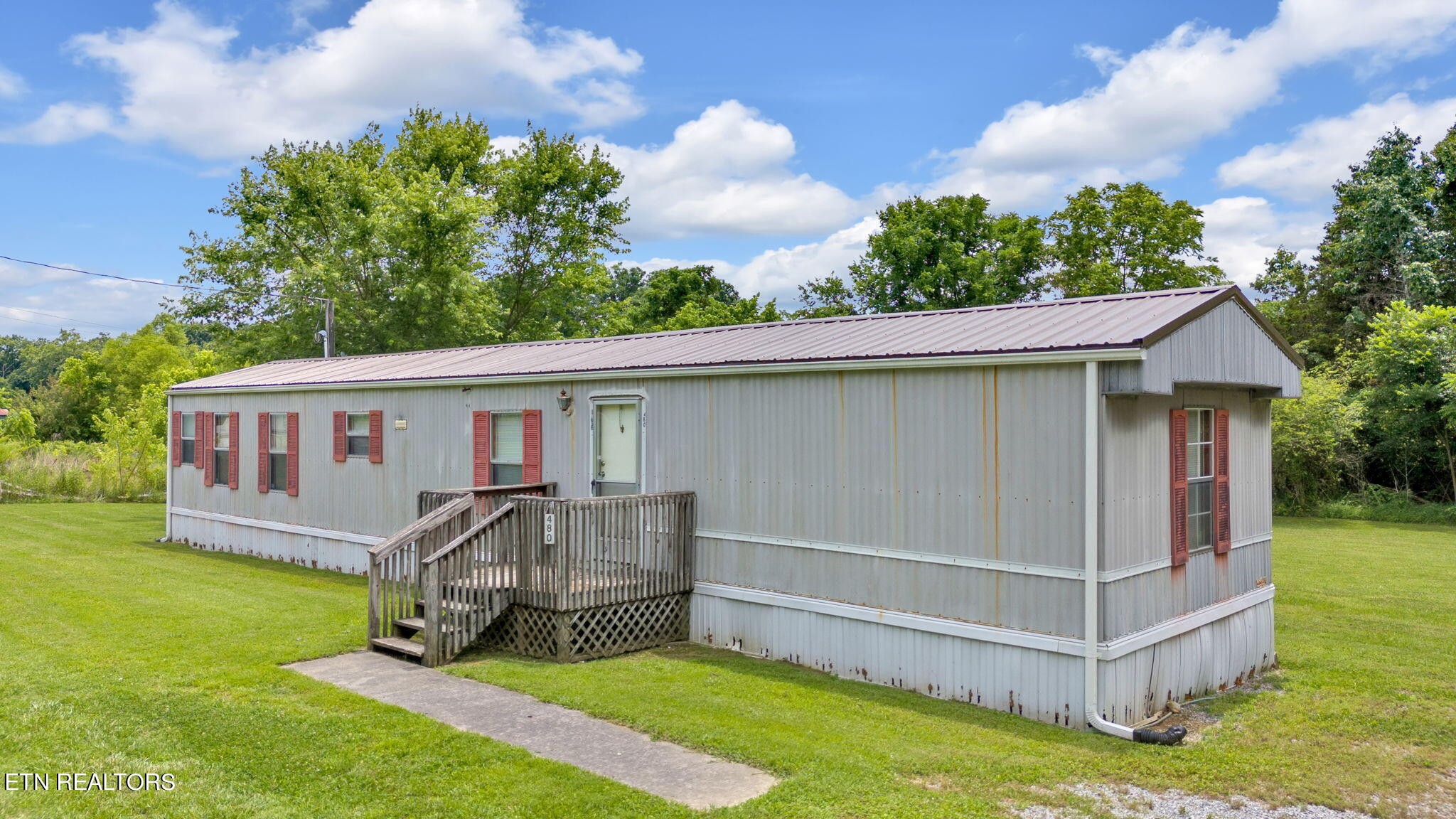480 Oasis Road Bulls Gap, TN 37711 - Photo 3 of 16 a view of a house with a yard and sitting area