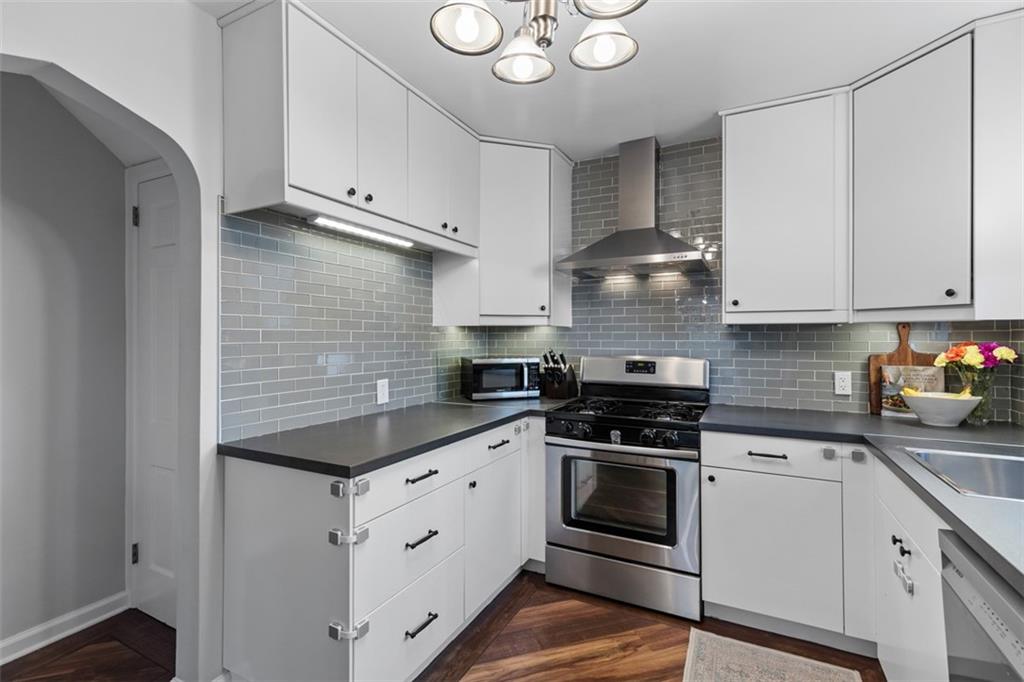 8 Court Place McKees Rocks, PA 15136 - Photo 11 of 32 a kitchen with cabinets stainless steel appliances and a sink