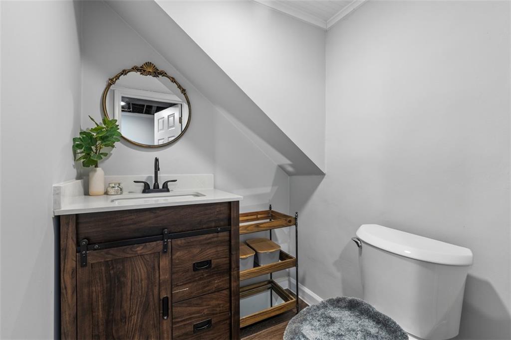 8 Court Place McKees Rocks, PA 15136 - Photo 24 of 32 a bathroom with a toilet a sink and mirror