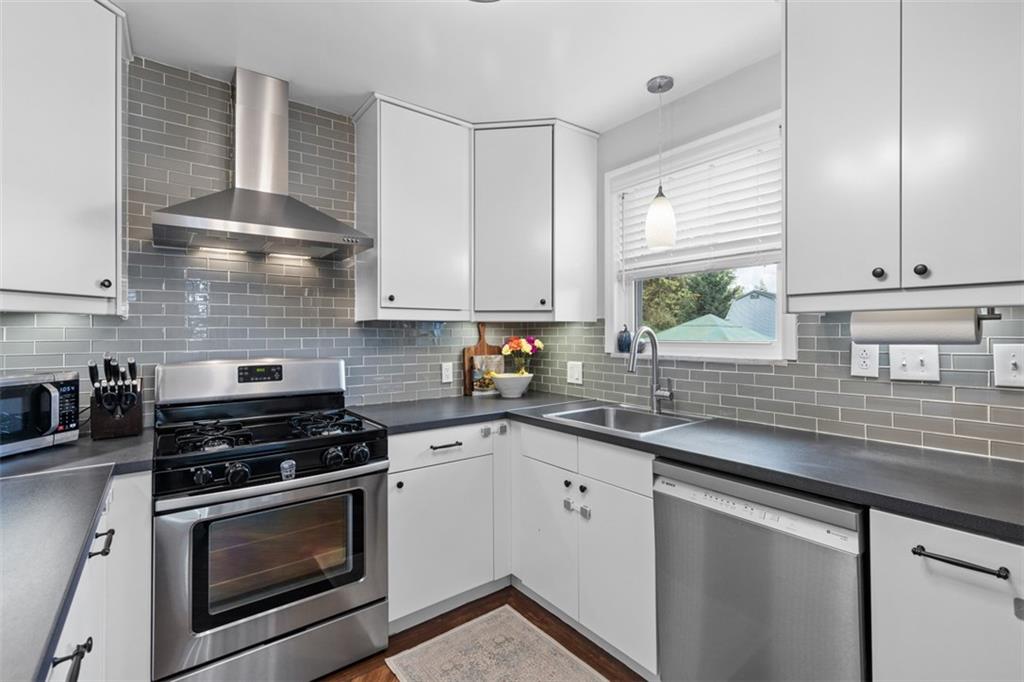 8 Court Place McKees Rocks, PA 15136 - Photo 10 of 32 a kitchen with stainless steel appliances a stove sink and cabinets