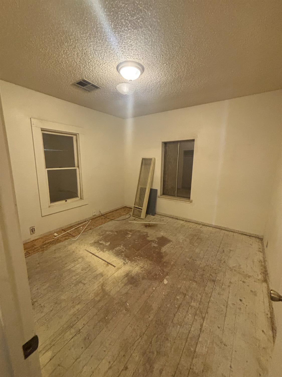 301 East Merced Street Avenal, CA 93204 - Photo 14 of 21 a view of a livingroom with a space and wooden floor