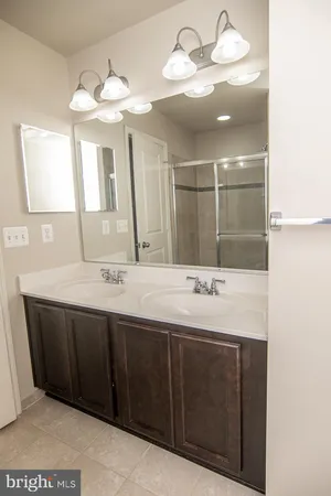a bathroom with a sink double vanity and a mirror