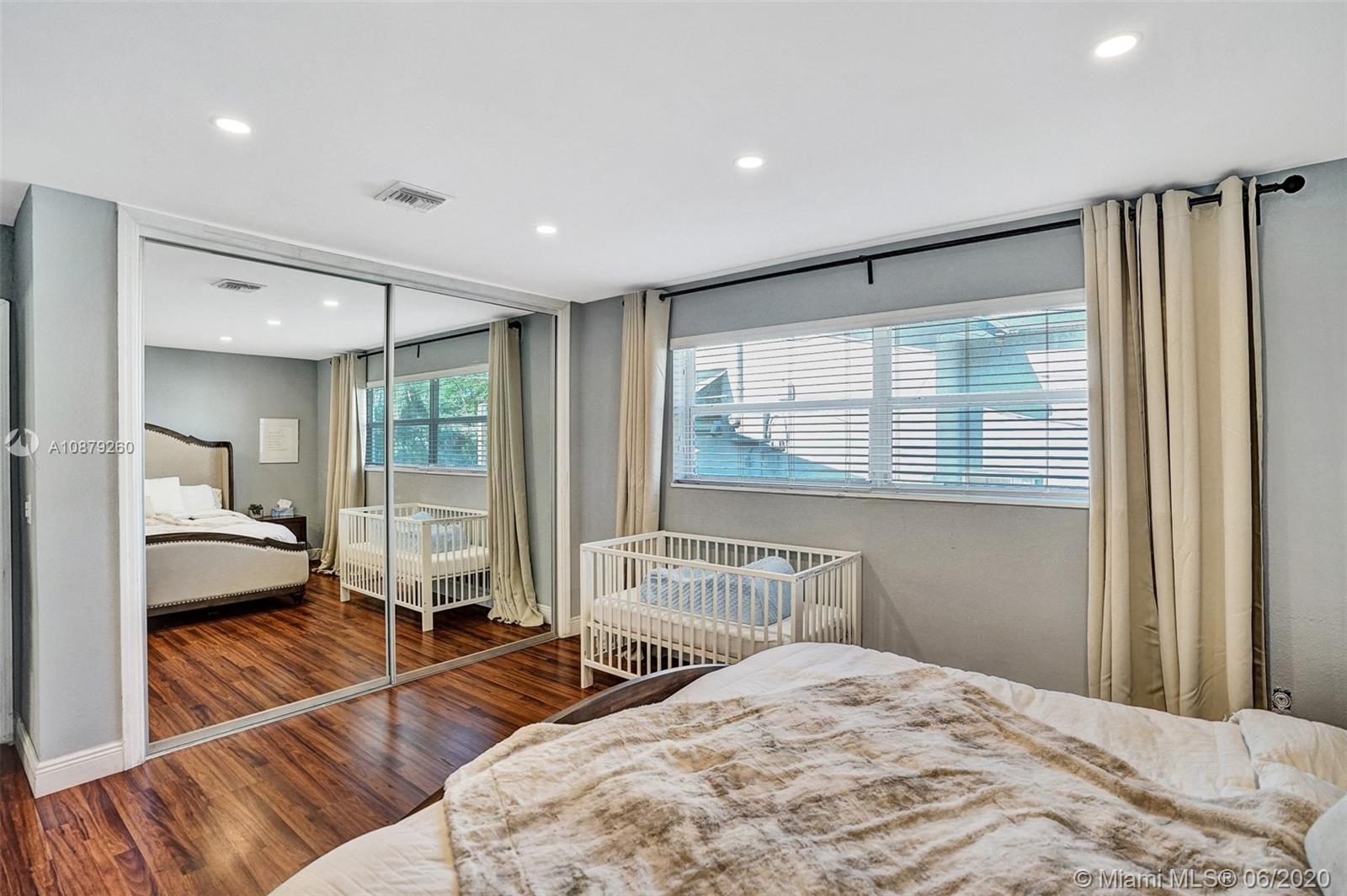 4214 West Park Road Hollywood, FL 33021 - Photo 24 of 38 Master bedroom closet has floor to ceiling mirrored doors and built-ins.