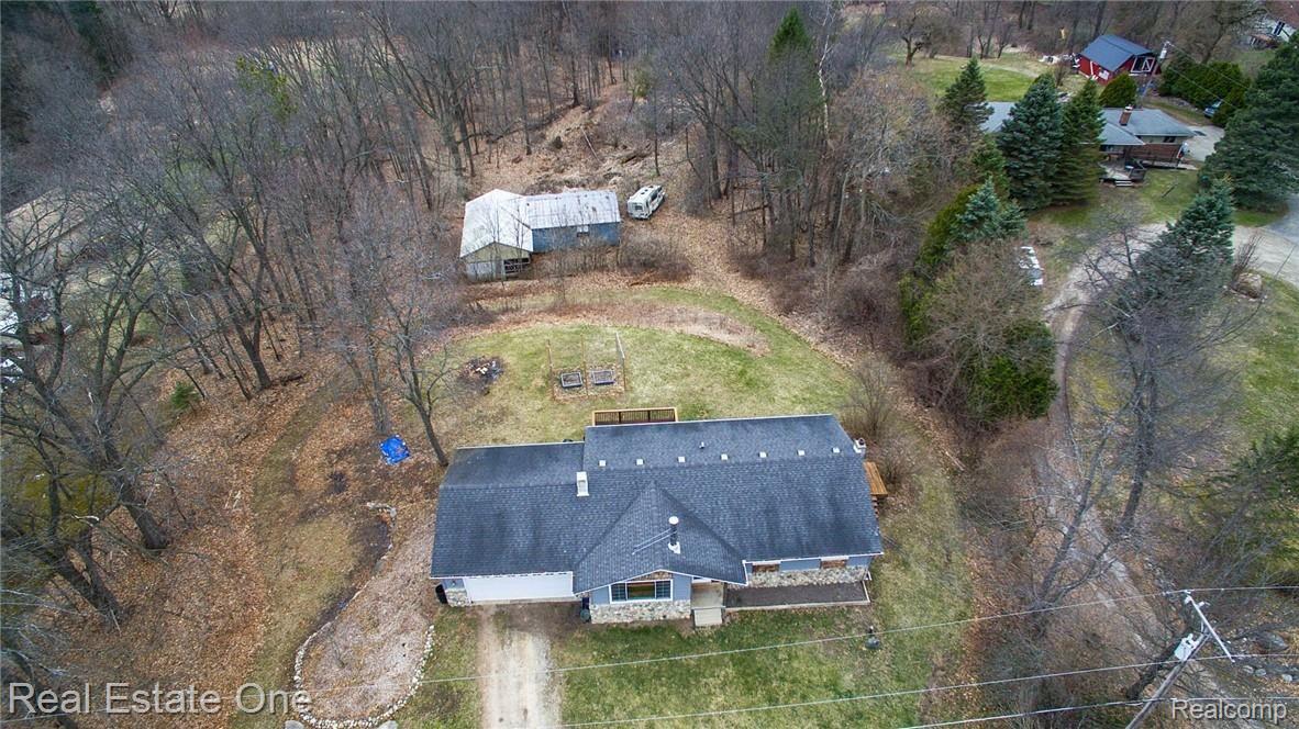 2655 Porter Road White Lake, MI 48383 - Photo 3 of 39 Property includes wooded acreage and a barn.