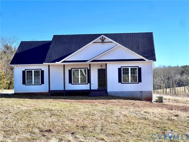 a house that has a large tree in front of it