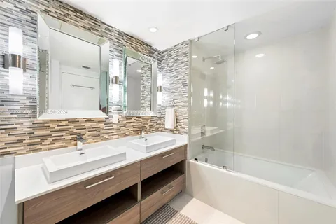 a bathroom with a bathtub and a sink