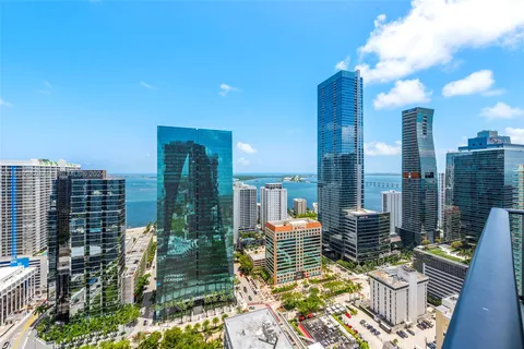 a view of a balcony with dining table and chairs