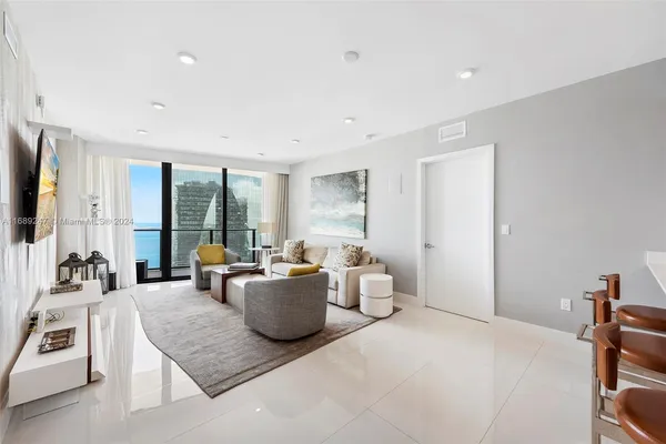 a living room with furniture and a large window