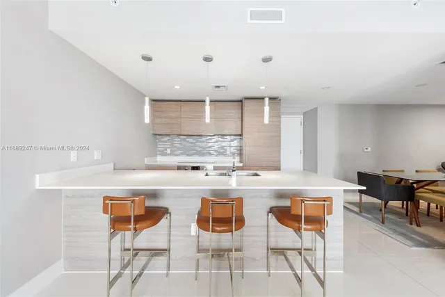 a kitchen with cabinets a counter top space and stainless steel appliances