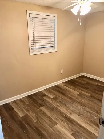 a view of a room with wooden floor and fan