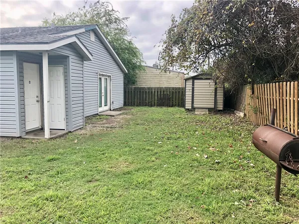 a backyard of a house with table and chairs