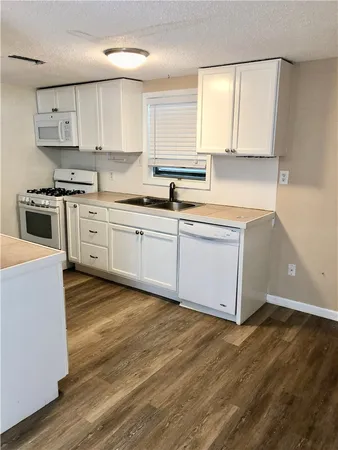 a kitchen with stainless steel appliances granite countertop a stove and a sink