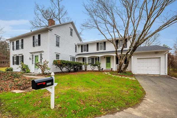 a front view of a house with a yard table and chairs