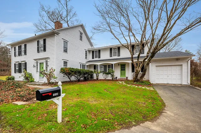 a front view of a house with a yard table and chairs