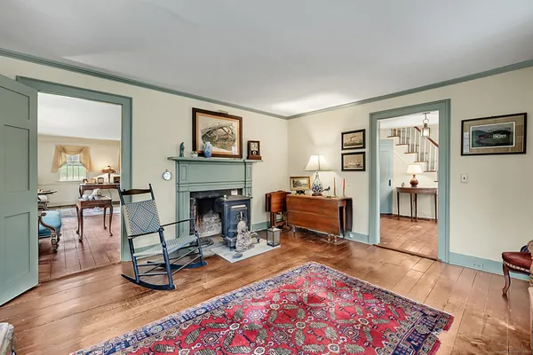 a living room with furniture a piano and a fireplace