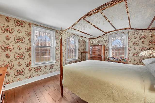 a bedroom with a large bed and a window