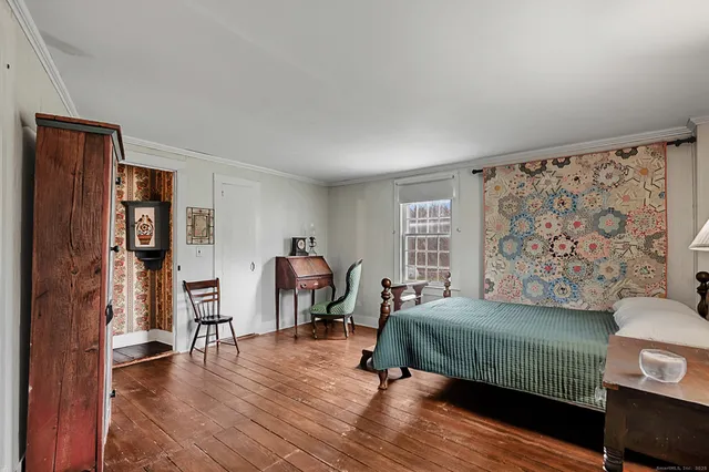 a bedroom with furniture and a book shelf