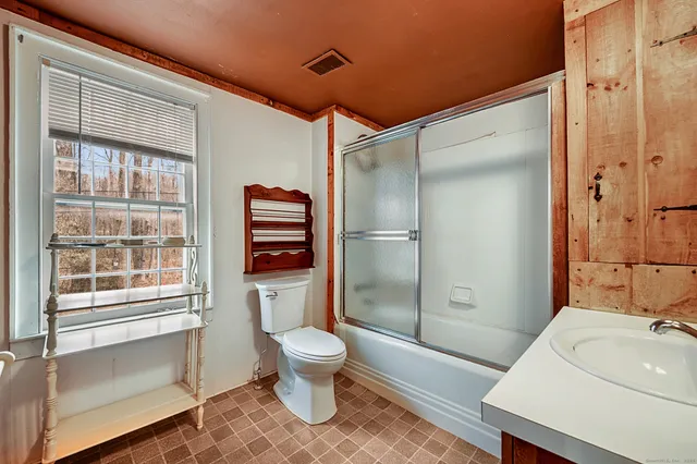 a bathroom with a sink toilet and shower