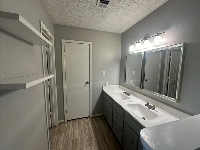 a bathroom with a double vanity sink and mirror