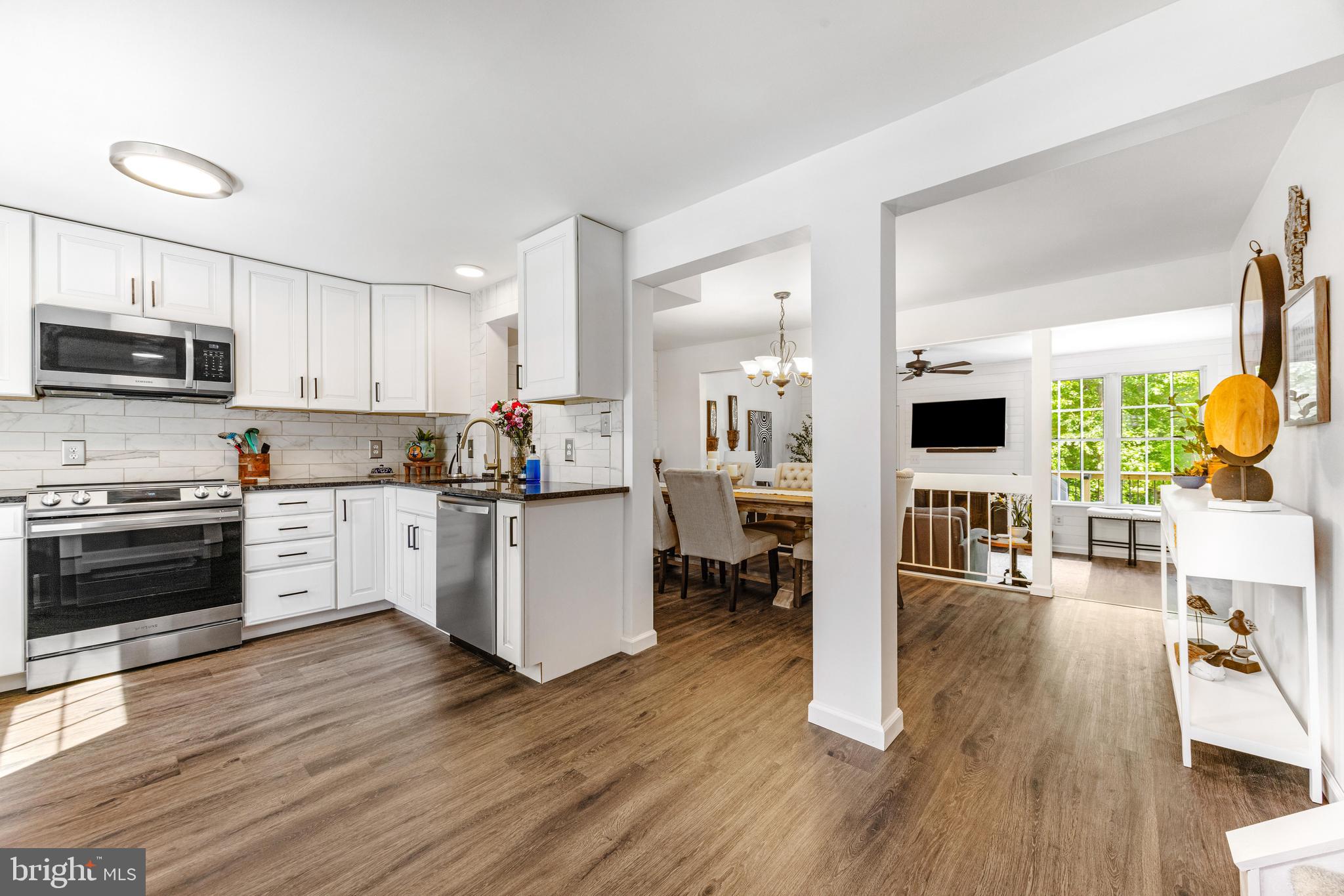 9023 Deviation Road Nottingham, MD 21236 - Photo 1 of 47 a kitchen with sink cabinets and wooden floor