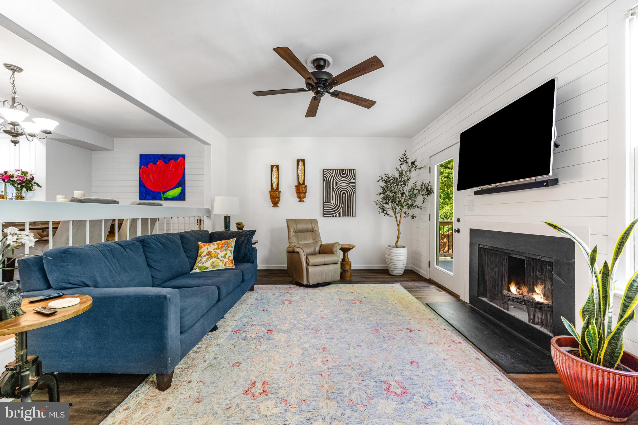 9023 Deviation Road Nottingham, MD 21236 - Photo 19 of 47 a living room with furniture a flat screen tv and a fireplace