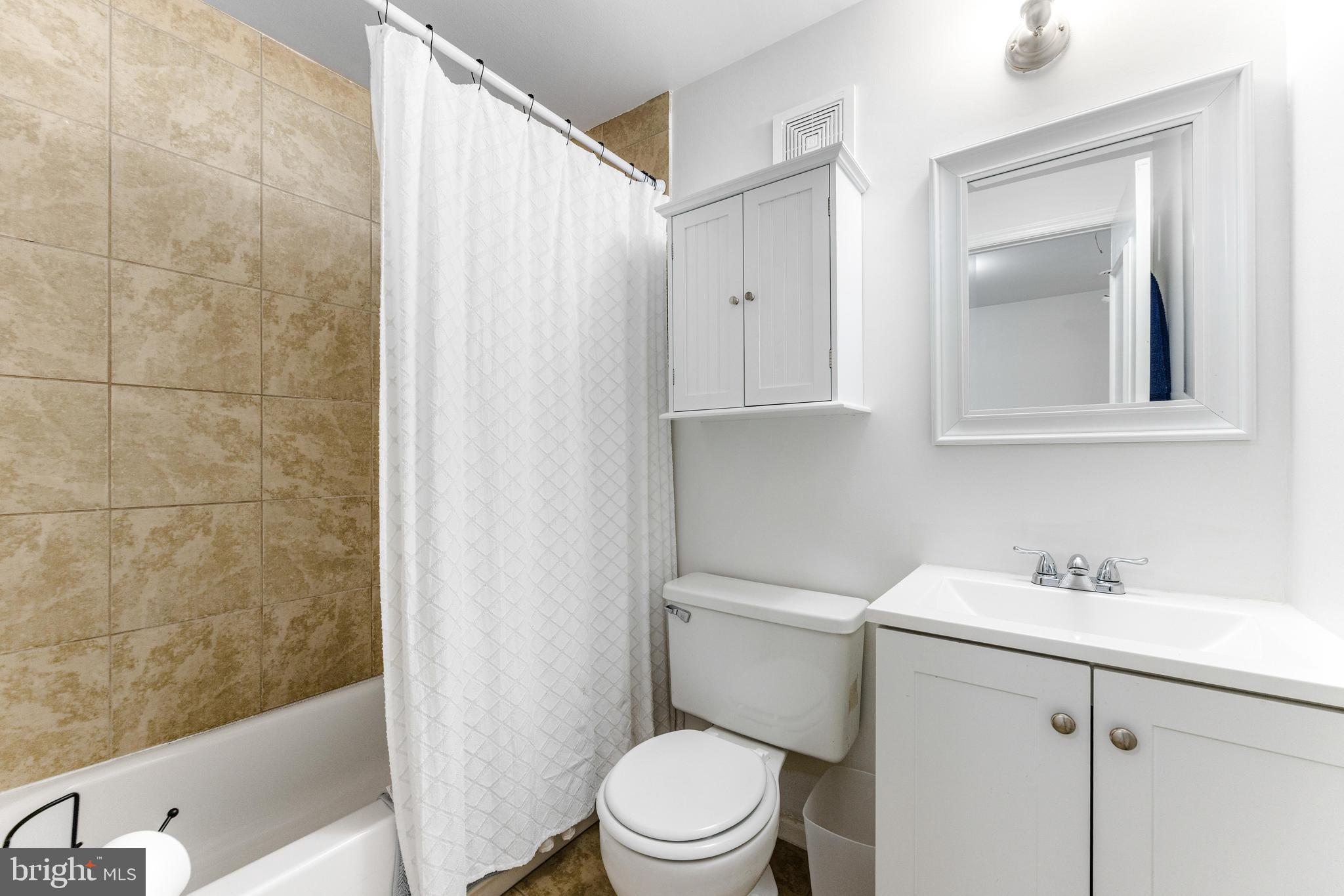 9023 Deviation Road Nottingham, MD 21236 - Photo 28 of 47 a bathroom with a sink a toilet and shower