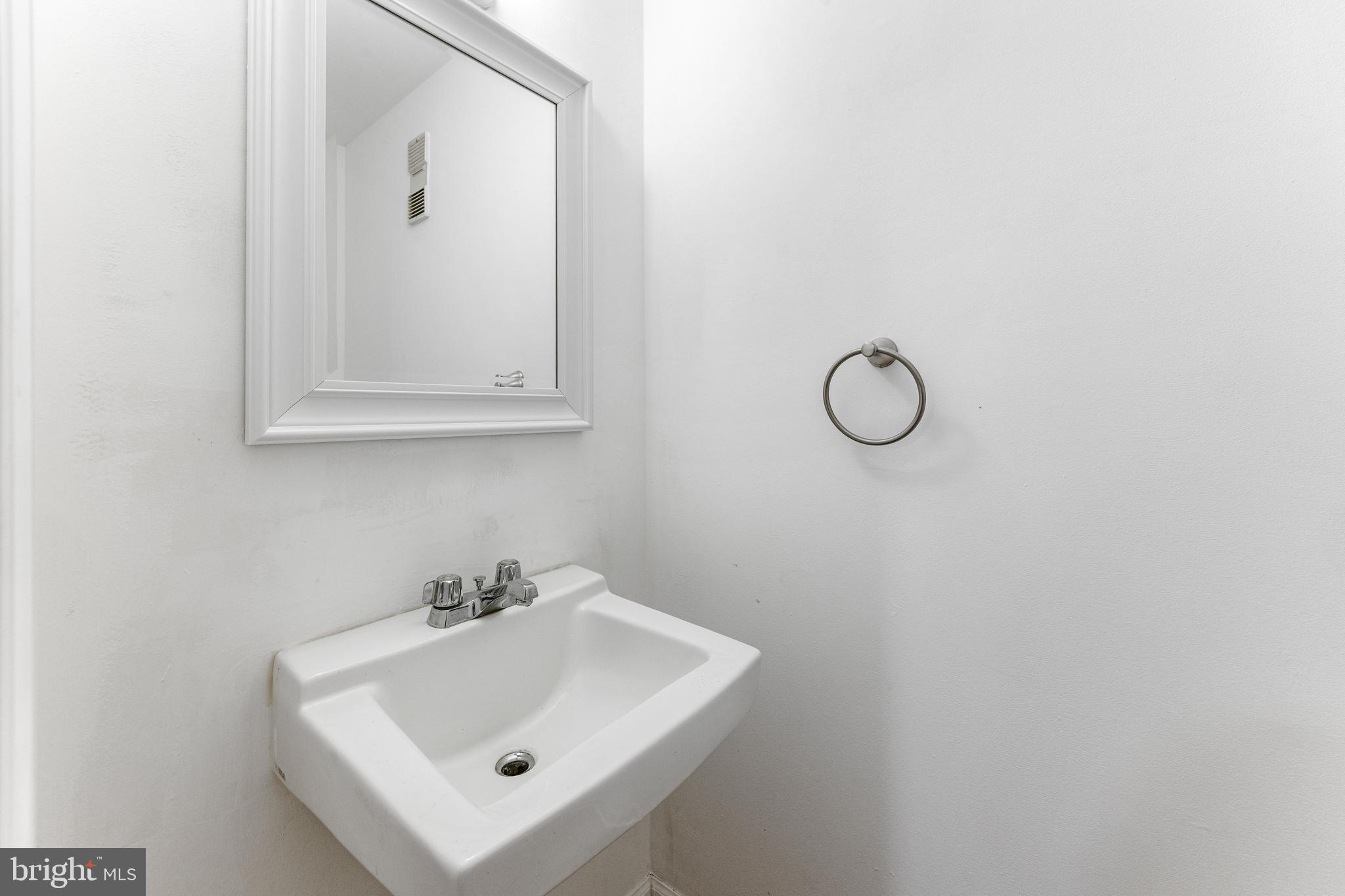 9023 Deviation Road Nottingham, MD 21236 - Photo 38 of 47 a bathroom with a sink and a mirror