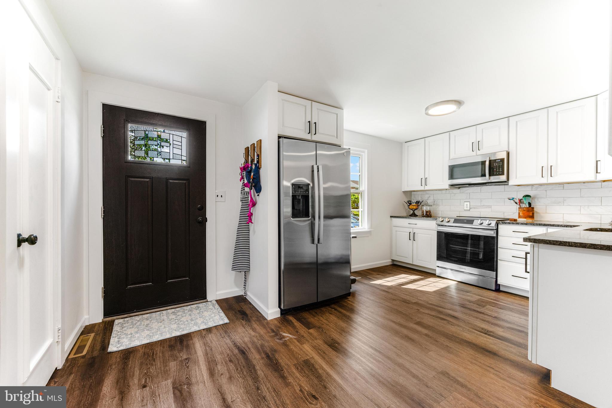 9023 Deviation Road Nottingham, MD 21236 - Photo 5 of 47 a kitchen with granite countertop a refrigerator and a stove top oven