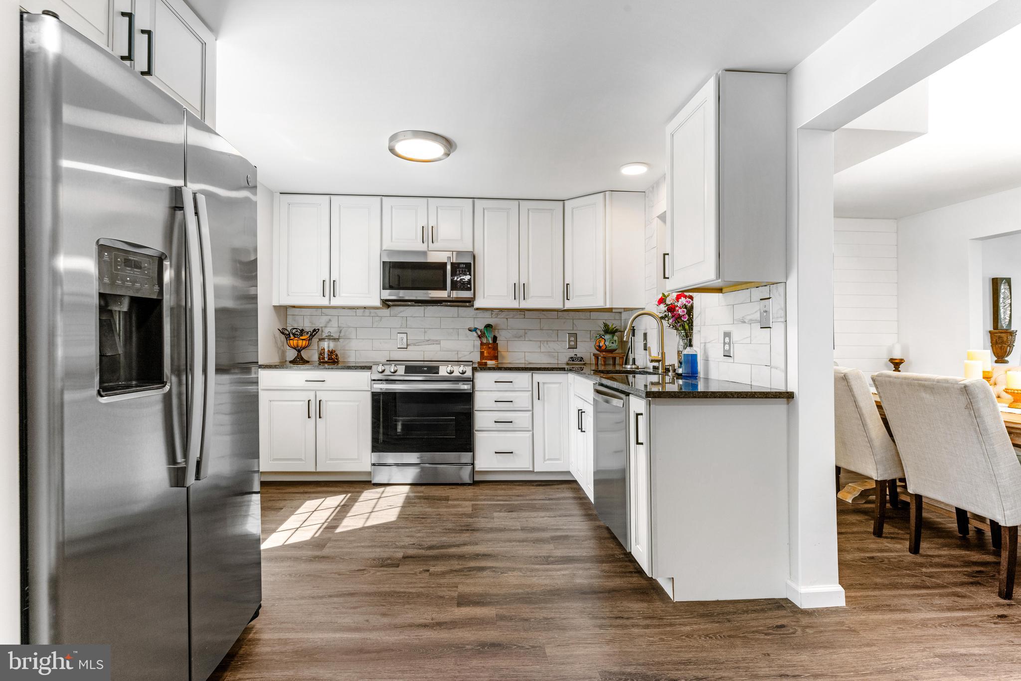9023 Deviation Road Nottingham, MD 21236 - Photo 6 of 47 a kitchen with stainless steel appliances granite countertop a refrigerator a stove top oven a sink and dishwasher