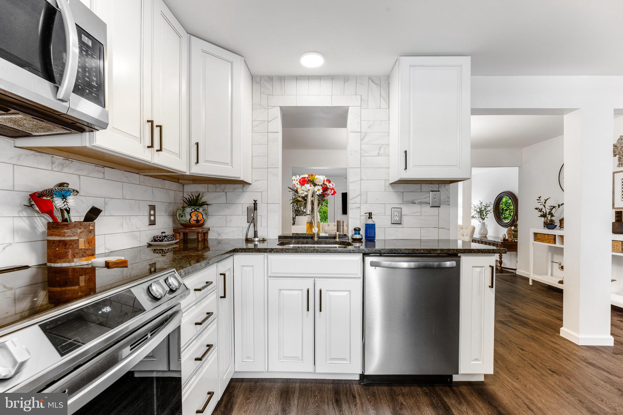 9023 Deviation Road Nottingham, MD 21236 - Photo 8 of 47 a kitchen with granite countertop a sink cabinets stainless steel appliances and wooden floor
