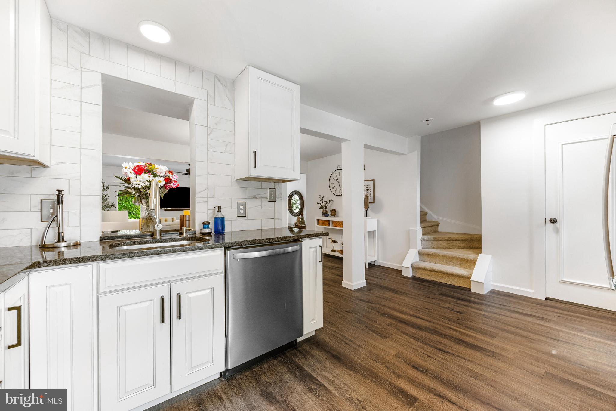 9023 Deviation Road Nottingham, MD 21236 - Photo 9 of 47 a kitchen with granite countertop a sink cabinets and wooden floor