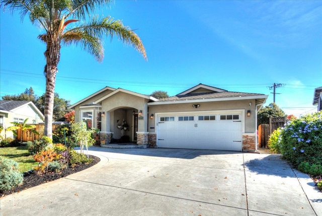 a front view of a house with a garden and yard