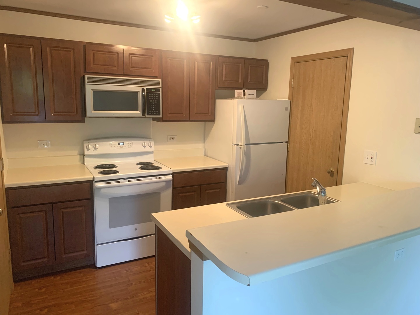 1352 Cunat Court, Unit 2C Lake In The Hills, IL 60156 - Photo 2 of 11 a kitchen with a sink a stove a microwave and refrigerator
