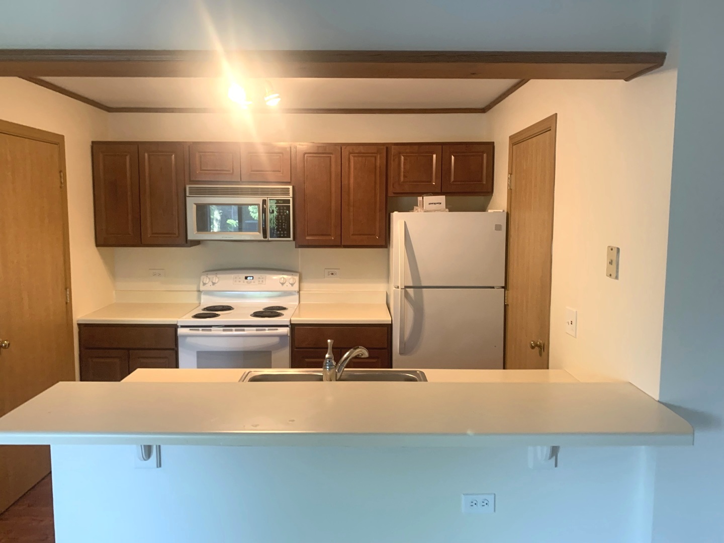 1352 Cunat Court, Unit 2C Lake In The Hills, IL 60156 - Photo 3 of 11 a kitchen with stainless steel appliances granite countertop a refrigerator a stove and a sink with wooden floor