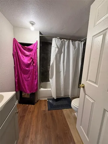 a view of a room with wooden floor and windows