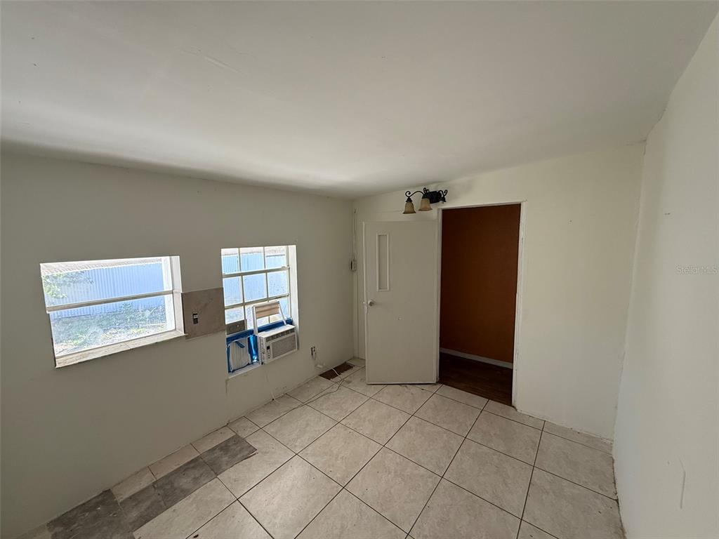 9013 Burr Drive Polk City, FL 33868 - Photo 12 of 20 a view of empty room with wooden floor and windows