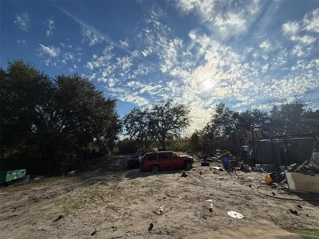 a view of backyard with parked car