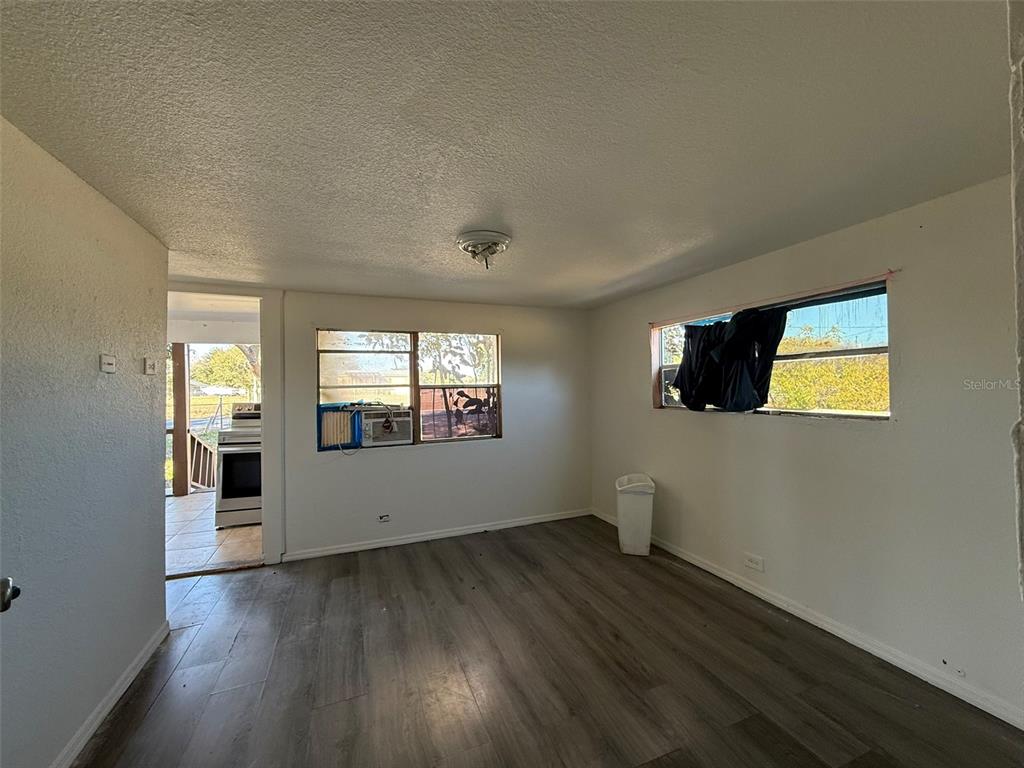 9013 Burr Drive Polk City, FL 33868 - Photo 5 of 20 a view of empty room with wooden floor and fan